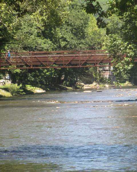 The Oconaluftee River running under a footbridge in Cherokee