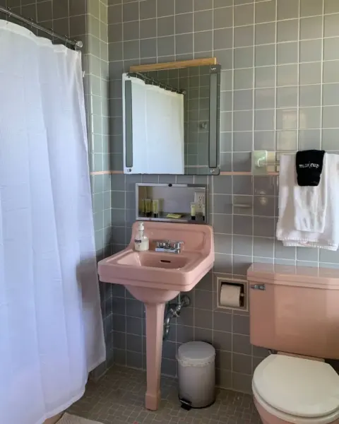 Original 1940s tile and pink sink in the Scarlett Suite bathroom