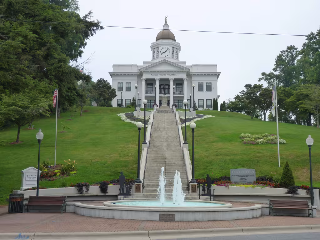 The white-domed historic Jackson County Courthouse at the top of a long flight of steps above Main Street in Sylva